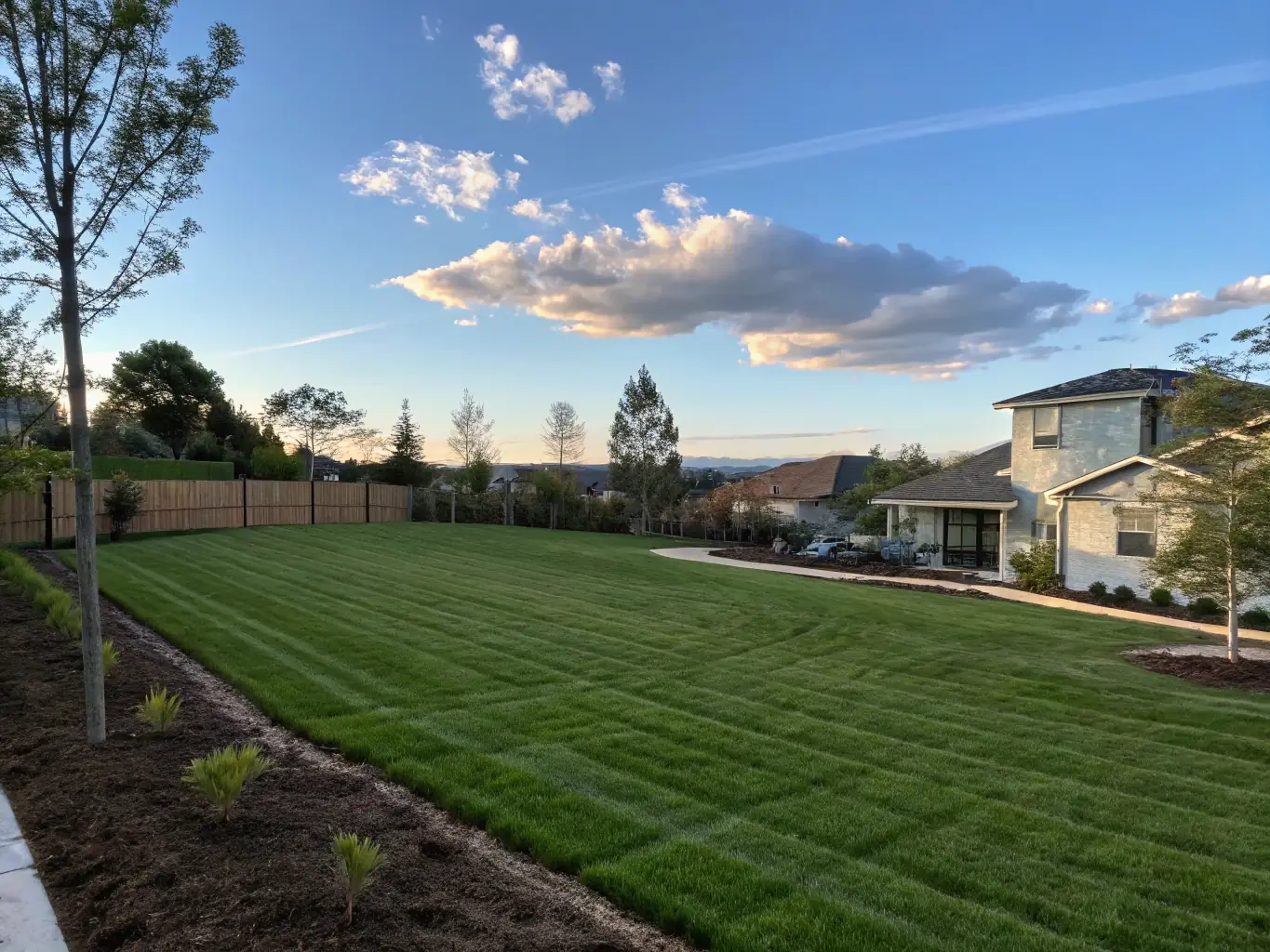 A beautifully landscaped yard prepared by Trust Drilling Inc., showcasing the smooth and even terrain ready for planting.